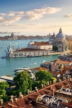 an aerial view of venice, italy with the grand canal in the foreground and other buildings