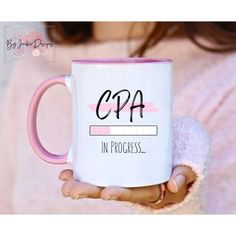 a woman is holding a coffee mug with the words copa in progress on it