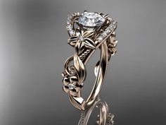 an intricately designed engagement ring with a flower and vine design on the band, set in 18k gold