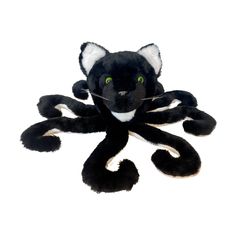 a black and white stuffed animal with green eyes