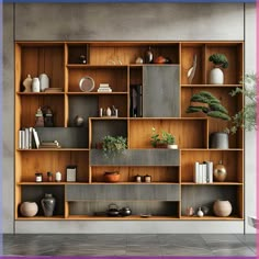 a book shelf filled with lots of different types of vases and plants on top of wooden shelves