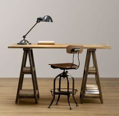 a desk with a chair and lamp on it