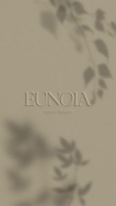 the word eunoia is written in white letters on a beige background with leaves