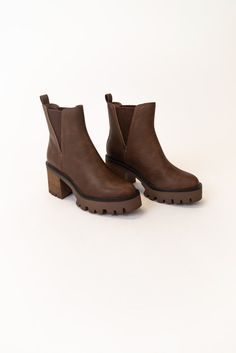 The Rusty is a dark brown bootie featuring a 3" heel and a small platform. Take inspo from our pictures and pair with your favorite boot socks and a floral dress! 3 1/4" heel; 1/2" platform 9 1/4" shaft; 10 1/2" calf circumference Contoured footbed Synthetic upper and lining/rubber sole *FINAL SALE* Favorite Boots, Brown Booties, Timor Leste, Resort Collection, Plus Size Shopping, Boot Socks, Swimsuit Cover, Caicos Islands