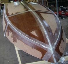 a wooden boat being worked on in a shop