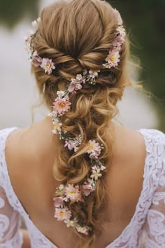 a woman with flowers in her hair is wearing a flowered headpiece and braid