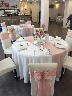 the tables are decorated with pink and white linens