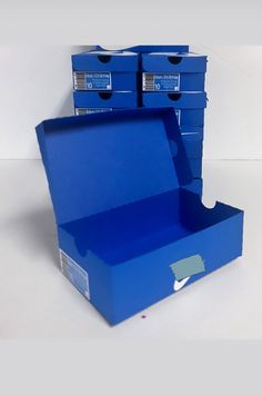 two blue boxes are stacked on top of each other and one is open to reveal the contents