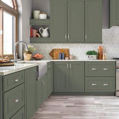 a kitchen with gray cabinets and tile flooring