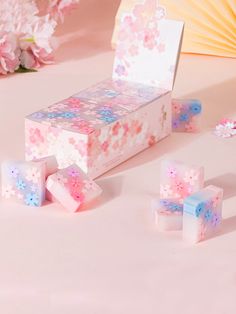 three pink and blue dices sitting next to each other on top of a table