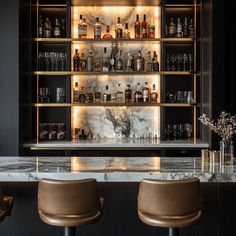 an elegant bar with marble counter tops and leather stools in front of the bar