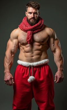 a shirtless man wearing red pants and a scarf