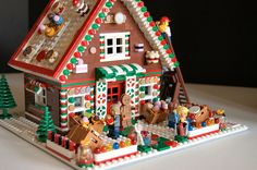 a gingerbread house is decorated with legos and candy canes for christmas time