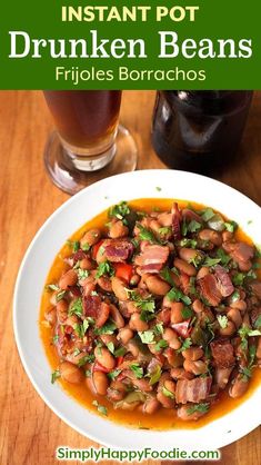 a white plate topped with beans next to a glass of beer