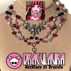 "A 14\" necklace with a 3\" extension chain, inspired by Draculaura from monster high. Features gemstone beads such as obsidian, rose quartz, ;pink tourmaline  and pink catseye.  Made with durability and fashion in mind with a silver bat centerpiece. Perfect for cosplay, everyday wear or just representing the monster high fandom!" Quartz Pink, Savannah Ga, Nov 6, Pink Tourmaline, Monster High, Savannah, Rose Quartz, Tourmaline, Gemstone Beads