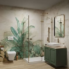 the bathroom is decorated with tropical wallpaper and gold fixtures, including a glass shower