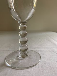 an empty wine glass sitting on top of a table