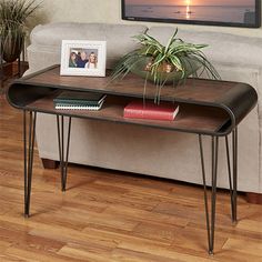 a living room with a couch, coffee table and pictures on the wall