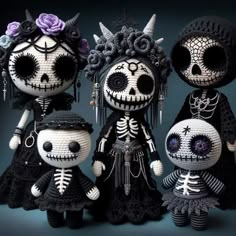 three crocheted dolls are dressed in black and white