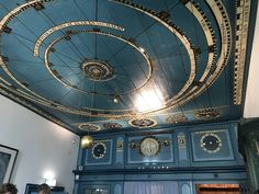 an ornate ceiling in a room with blue walls