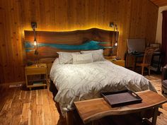 a bedroom with wood paneled walls and wooden flooring