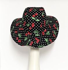 Wide Brim Sun Hat, cherry print and polka dot cotton blend fabric , lined in rayon print, the hat has a 2 section crown 3 1/2 " in length and a one piece 4" brim, 1" soft cotton band inside. One size fits most up to 23" Made in USA Machine wash cold/ hand dry press if needed Fitted Lined Hat For The Beach, Retro Red Summer Hats, Adjustable Brimmed Lined Hat, Retro Wide Brim Sun Hat For Summer, Retro Adjustable Wide Brim Sun Hat, Retro Wide Brim Adjustable Sun Hat, Fitted Cotton Hat With Flat Brim, Retro Cotton Sun Hat For Beach, Retro Cotton Sun Hat For Summer