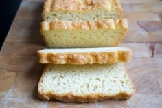 two loaves of bread sitting on top of a cutting board with the words keto bread