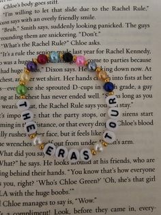 an open book with beads on it and the words eras written in different languages,