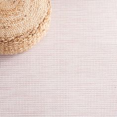 a straw hat sitting on top of a table next to a white cloth covered floor