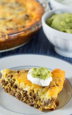 a piece of quiche on a plate with guacamole