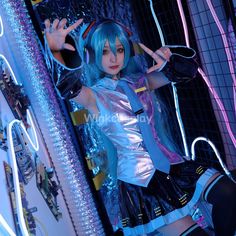 a woman with blue hair is posing in front of neon lights and holding her hands up