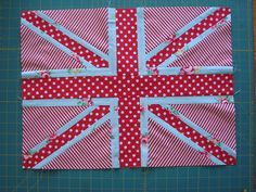 the union jack quilt is made up of red and white polka dot fabric, which has been stitched together