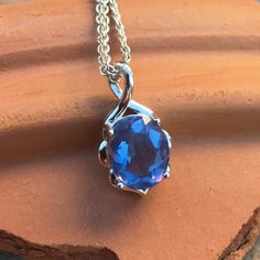 a necklace with a blue stone hanging from it