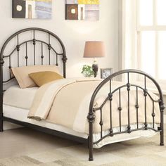 a metal bed frame in a bedroom with white walls and beige carpeted flooring