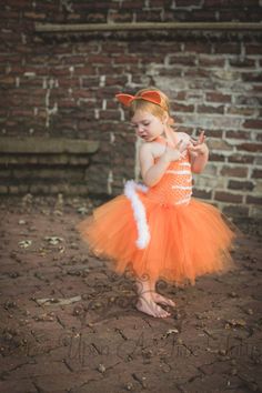 "Orange White Cat Tutu Dress An unlined orange crochet tutu top embellished with white felt detail, a full orange tutu, and a marabou feather \"tail\" attached to the back. Cat ears can be added through the drop down menu. Sizes and Lengths: (Tail will be longer) 0-6 Months Length - 6 Inches 6- 12 Months Length - 7 Inches 12M - 2T 8 inch length 3T - 4T 10 inch length 5 - 6 12 inch length 7 - 8 14 inch length 8/10 14 inch length 10 - 12 14 inch length 12 - 14 14 inch length Perfect for gift givin Toddler Cat Costume Diy, Orange Cat Costume, Toddler Cat Costume, Cat Costume Kids, Cat Costume Diy, Halloween Costume Kids, Tutu Top, Crochet Tutu, Orange And White Cat