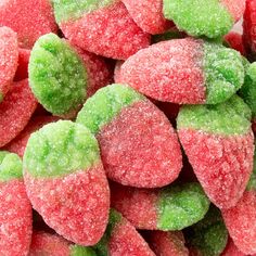 close up view of candy candies with green and red toppings on them, all covered in powdered sugar