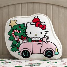 the hello kitty car pillow is next to a christmas tree