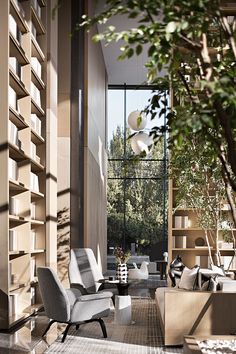 a living room filled with furniture next to a tall book shelf covered in lots of books