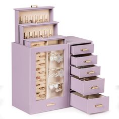 a purple jewelry box with five drawers and several rings in it on a white background