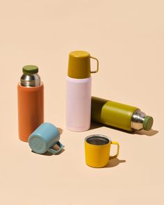 three different types of coffee cups and thermos