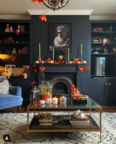 a living room filled with furniture and a fire place under a chandelier in front of a fireplace