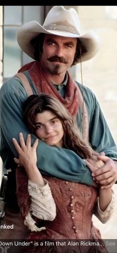 a man in a cowboy hat hugging a woman with her arm around him and the caption, down under is a film that also rickman