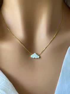 This delicate white opal cloud necklace is the perfect piece to add a touch of pure elegance to your look, this necklace is crafted from lab created white opal stones, creating a stunning effect as it reflects light. With intricate detailing and minimalist design, this necklace is sure to elevate your style and make you stand out from the crowd. Perfect for everyday wear, this necklace will become an indispensable part of your accessory collection - and it doesn't even have to be taken off! It is a perfect gift for yourself or your friends and family. Pendant: Lab Opal 7.3x12mm Chain: 18 inches 925 Sterling Silver Box Chain or Gold Plated Chain Over Sterling Silver Necklace length is fully adjustable by holding down the sliding bead and pulling on the chain. Wear it as a choker or longer b White Opal Necklace With Delicate Chain, Opal Pendants, Opal Necklace, White Opal, October Birth Stone, Gold Plated Chains, Sterling Silver Necklaces, Necklace Lengths, Silver Necklace