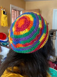 a woman wearing a multicolored crocheted hat