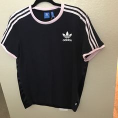 Adidas Size Medium Navy Blue With Light Pink Stripes Old School Logo Blue Tag T-Shirt 2 Materials The Back Is Sleek Front Is Jersey Knit New Without Tags ** Flawed** One Small Hole In The Seam At The Bottom Back In Photos Spring Adidas Athleisure T-shirt, Adidas Athleisure T-shirt For Spring, Blue Athleisure Tops With Three Stripes, Blue Three Stripes Tops For Summer, Adidas Blue Tops With Three Stripes, Adidas Blue Three Stripes Top, Blue Adidas Tops With Three Stripes, Adidas Three Stripes Summer Tops, Adidas Summer Tops With Three Stripes