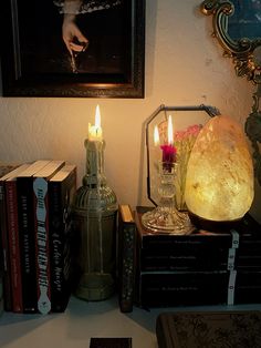 some books and candles are sitting on a table