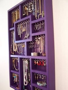 a purple shelf filled with lots of jewelry