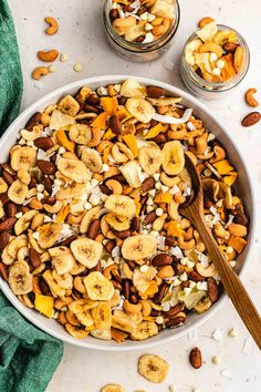 a white bowl filled with nuts and bananas