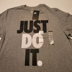 Nike Men's Just Do It Graphic T-Shirt Grey Color Grey With Black And White Lettering Just Do It Add Some Statement-Making Style To Your Sporty Essentials With The Iconic Slogan Boldly Printed At The Front Of This Just Do It T-Shirt From Nike. Crewneck Imported Printed Slogan At Front Nike Gray T-shirt With Logo Print, Nike Cotton T-shirt In Athletic Heather, Nike Gray Tops With Letter Print, Nike T-shirt In Athletic Heather With Logo Print, Nike Athletic Heather T-shirt With Logo, Nike Gray Tops With Logo Print, Nike Gray Top With Logo Print, Nike Gray Crew Neck Shirt, Nike Gray Short Sleeve Shirt