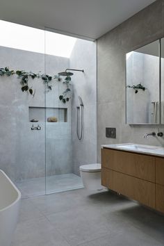 a bathroom with a sink, toilet and shower in it's own area next to a bathtub